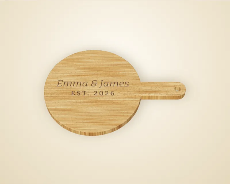 A round oak paddle board engraved with Emma and James